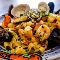 Fettuccini Pescatore · Fresh noodles with scallops, shrimps, lobster meat, mussels, clams, Italian parsley and fres...