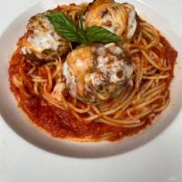 Meatballs Parmigiana · House made beef and pork meatballs topped with Mozzarella, served with spaghetti pomodoro.