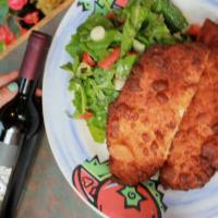 Chicken Capricciosa · Breaded chicken cutlet with an entree size salad of arugula, endives, tomato and lemon vinai...