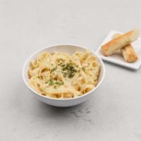Fettuccini Alfredo · Fettuccine pasta tossed with our freshly made cream sauce. Garnished with parsley and freshl...