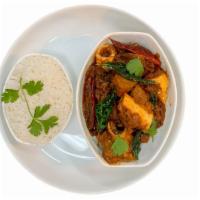 Andhra Chicken Curry · Bone-in chicken is slow-cooked in home-style curry sauce , served with a side of aromatic ba...