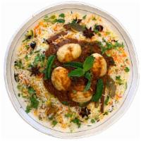 Egg Biryani · Golden fried hard boiled eggs are tossed in house made onion and herbs gravy then layered in...