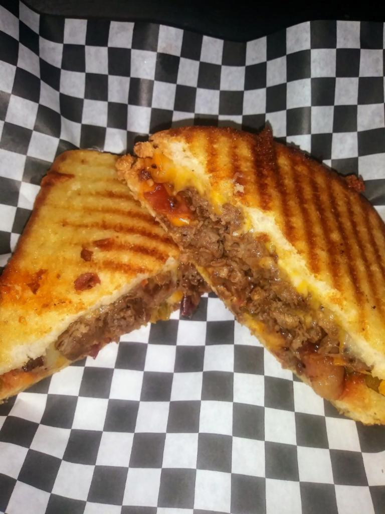 Angry Steak Melt · Season sauteed steak, jalapeno peppers, bacon, cheddar Jack cheese, mad sauce, grilled golden brown, served with house made chips or french fries 