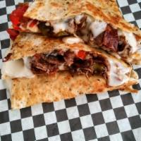 Really Philly Quesadilla · Grilled  seasoned steak, peppers, mushrooms,onions, bacon and mozzarella cheese, on a grille...