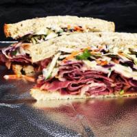 Seedy Pastrami Sandwich · Pastrami, melted Swiss cheese, seedy slaw, garlic aioli. 