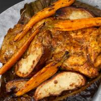 Pollo Pibil  · achiote rubbed half chicken cooked in banana leaves and finished in the wood oven, roasted c...