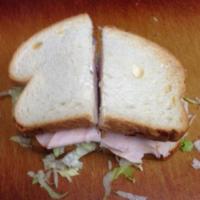 Turkey Breast Sandwich · Includes mayo, mustard, lettuce, tomato, onion and choice of cheese and bread.