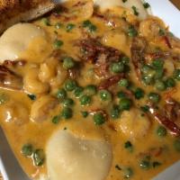 Lobster Ravioli with Shrimp · Peas and sundried tomatoes in a lobster cream sauce.