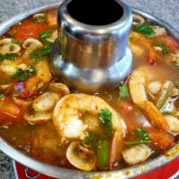 12. Shrimp Tom Yum · Spicy hot and sour soup with mushrooms, lemon grass, kaffir lime leaves, galangal and lime j...