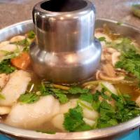 12. Fish Tom Yum · Spicy hot and sour soup with mushrooms, lemon grass, kaffir lime leaves, galangal and lime j...