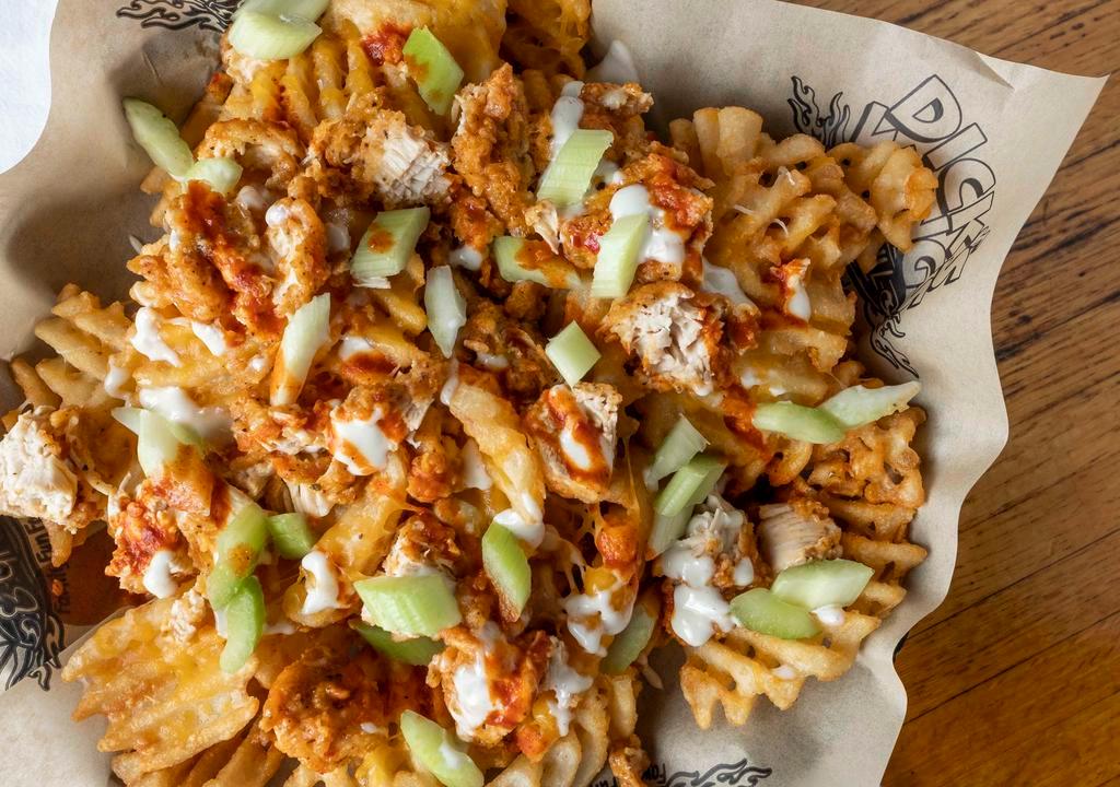 DWG Ultimate Waffle Fries · DWG's famous waffle fries. Fried golden crisp, topped with DWG boneless chicken, then tossed in your favorite flavor and finished with melted cheddar-jack cheese, chopped celery and your choice of bleu cheese or ranch dressing. 