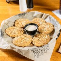 Fried Green Tomatoes · Fresh green tomatoes. Breaded and deep fried, topped with Parmesan cheese and garlic pepper ...