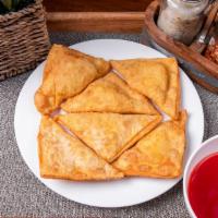 12. Crab Rangoon  · 8 pieces. Fried wonton wrapper filled with crab and cream cheese.