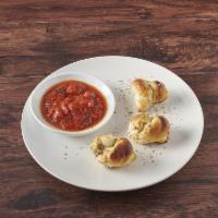 Garlic Knots · 3 pieces of Garlic Knots with a side cup of Marinara