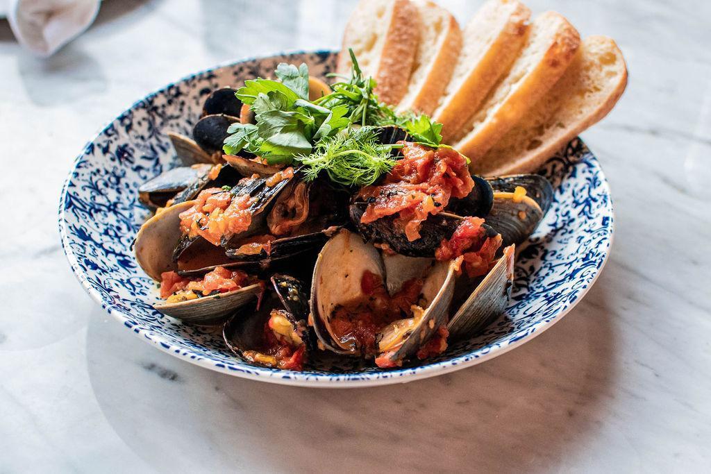 Steamed Clams & Mussels · Tomatoes, Saffron, White Wine, Seaweed & Roasted Garlic Butter, Grilled Bread (NF)