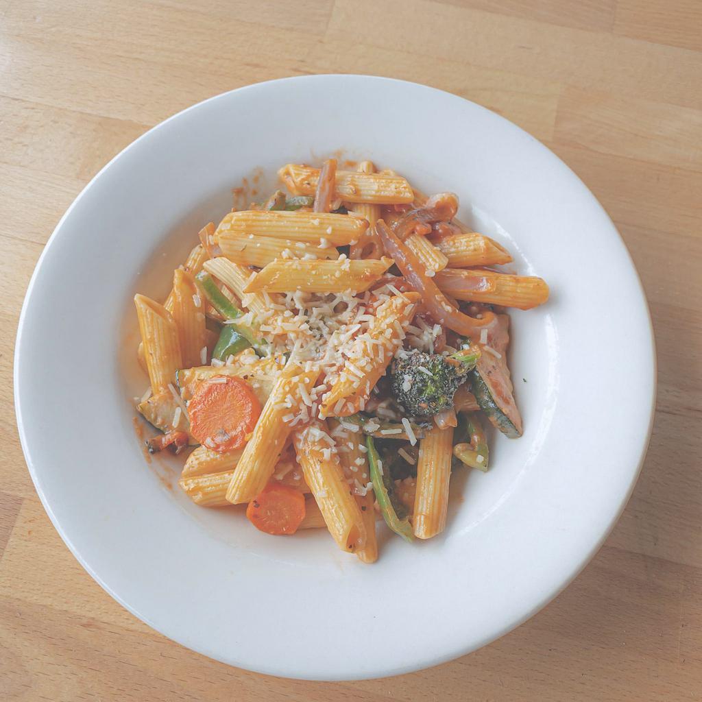 Pasta Primavera · Roasted carrots, broccoli, zucchini, red onions, green peppers tossed with penne pasta in pink sauce. Vegetarian.