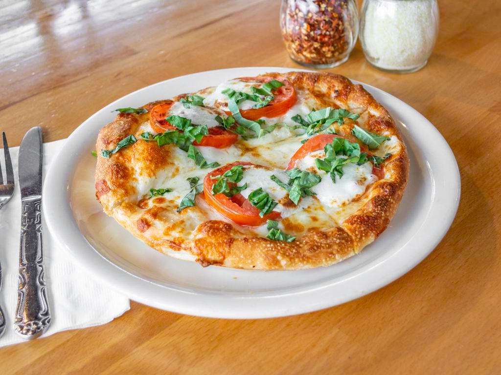 Margherita Pizza · Tomatoes, fresh garlic, fresh basil and Buffalo mozzarella, olive oil brushed crust.