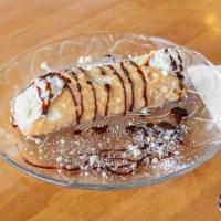 Cannoli · Crispy cannoli filled with homemade white chocolate ricotta cream, drizzled with chocolate.