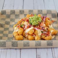 Lunch Loaded Totchos · Golden Tots layered with a velvety cheese sauce and your choice of meats. Topped with pico d...