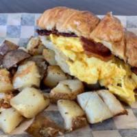 The B.A.E Sandwich · Our bacon and egg sandwich served on a croissant. Served with breakfast potatoes.