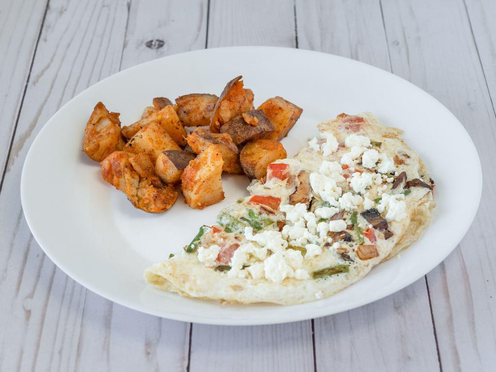 The Veggie Omelette · Our egg white omelette filled with asparagus, onions, tomatoes, mushrooms, and feta.