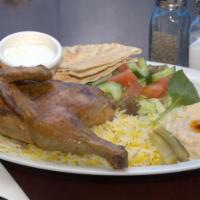 Half Chicken · Half chicken with one scoop of mandi rice served with hummus, salad and one pita bread.
