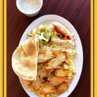 Chicken Shawarma Plate · Platter. Slices of chicken with hummus, salad, pickles, garlic sauce, pita bread and mandi r...
