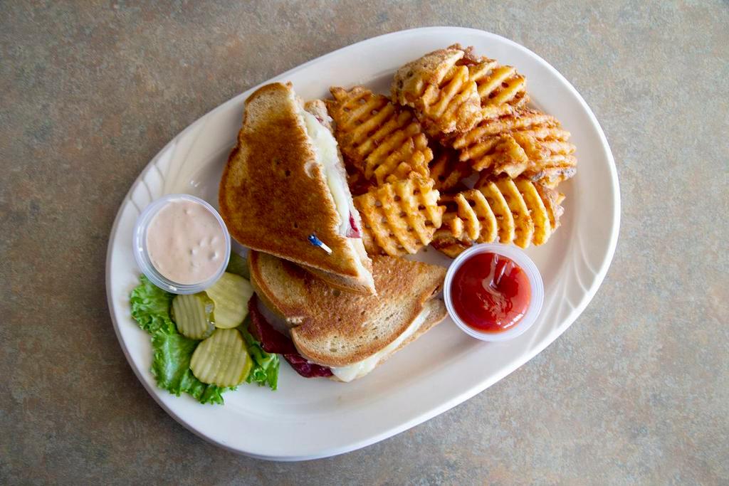 Reuben Sandwich · Tender, lean corned beef topped with sauerkraut and melted Monterey jack cheese served on grilled rye bread and 1,000 island dressing on the side.