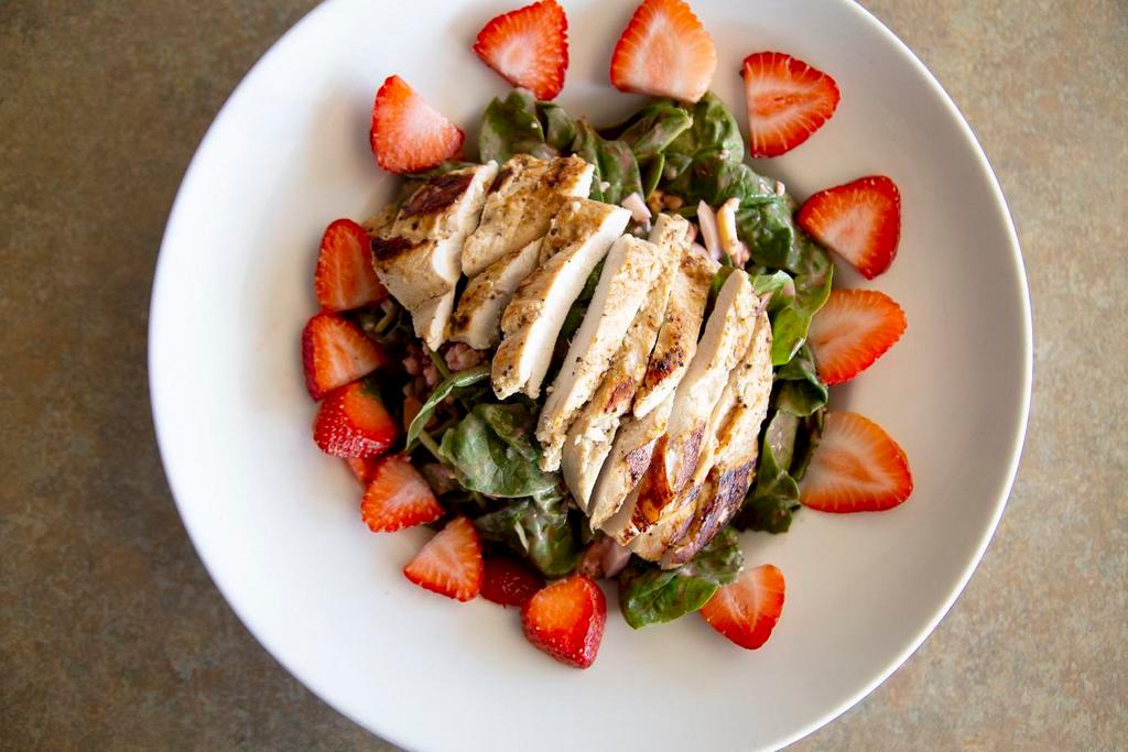 Spinach Salad · A pile of fresh spinach, tomato, egg, bacon, topped with bleu cheese crumbles and fresh strawberries. Served with raspberry vinaigrette or dressing of choice.