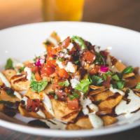 Ahi Poke Nachos · Nachos for grown-ups. We swapped the melty cheese out for Sashimi-grade chopped tuna, tomato...