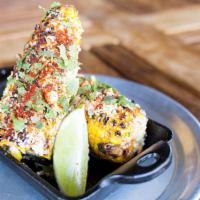 Grilled Mexican Corn Off the Cob · Basted in seasoning. Cotija cheese, cilantro, garlic mayo & fresh lime.