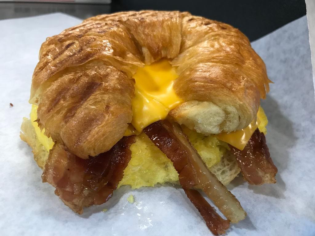 Breakfast Croissant · Scrambled eggs, American cheese & Bacon, butter Croissant. 