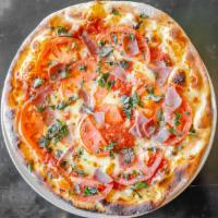 Antonella Pizza · Basil, sliced tomatoes and prosciutto.