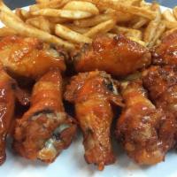 Chicken Wings · Cooked wing of a chicken coated in sauce or seasoning.