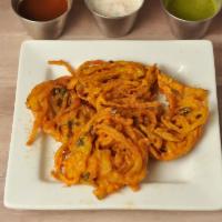 ONION PAKORAS · 4 PIECES. Sliced onion fritters with chick-pea flour, whole coriander & other spices.  Serve...