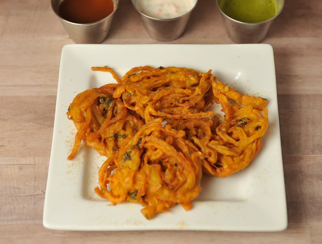 ONION PAKORAS · 4 PIECES. Sliced onion fritters with chick-pea flour, whole coriander & other spices.  Served with Tamarind & Mint-Yogurt sauce.