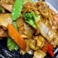 PAD SEE EW · Stir fry rice flat noodles with broccoli, onions, peppers, snow peas and carrots in a sweet ...