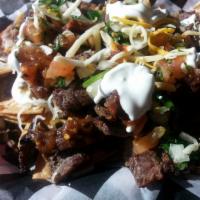 Nachos · Corn tortilla chips with your favorite meat and as many topics​ as you want.