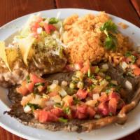 Bistec a la Mexicana · Strip of steak cooked in a tomato sauce, with onion and cilantro. Served with rice, beans, a...