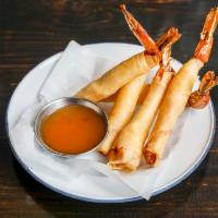Shrimp Shanks · Marinated shrimp rolled in spring rool rice paper and deep fried, served with homemade pinea...