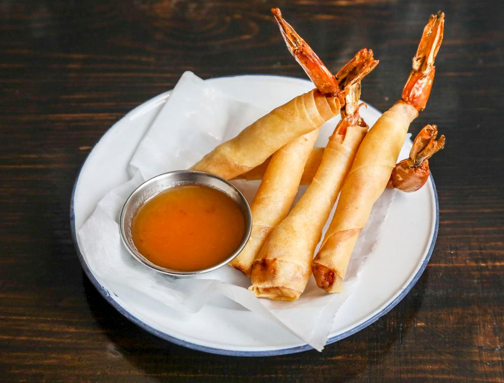 Shrimp Shanks · Marinated shrimp rolled in spring rool rice paper and deep fried, served with homemade pineapple sauce.