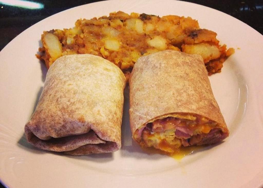 Breakfast Burrito · 3 scrambled eggs with ham, bacon, cheddar cheese and Tobasco sauce in a flour tortilla or whole wheat wrap. Served with home fries or french fries.