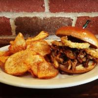 Southern BBQ Pork Sandwich · Slow-cooked, shredded pork roast, house-made BBQ sauce, and fried red onion on a grilled bri...