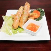 Imperial Spring Rolls · Grounded chicken, imitation crabmeat and seasoned vegetables wrapped in rice paper served wi...