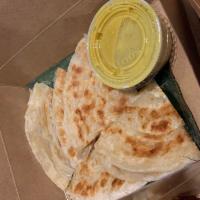 Roti (Pita Bread) · Pan-fried roti. Served with yellow curry dipping sauce.