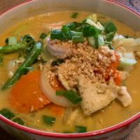 Deluxe Noodle · Rice noodle, chicken, and prawns, tofu, vegetable. Served with yellow curry soup topped with...