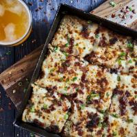Mashed Pizza · Mashed red skin potatoes, smoked mozzarella, bacon, green onions and garlic puree.