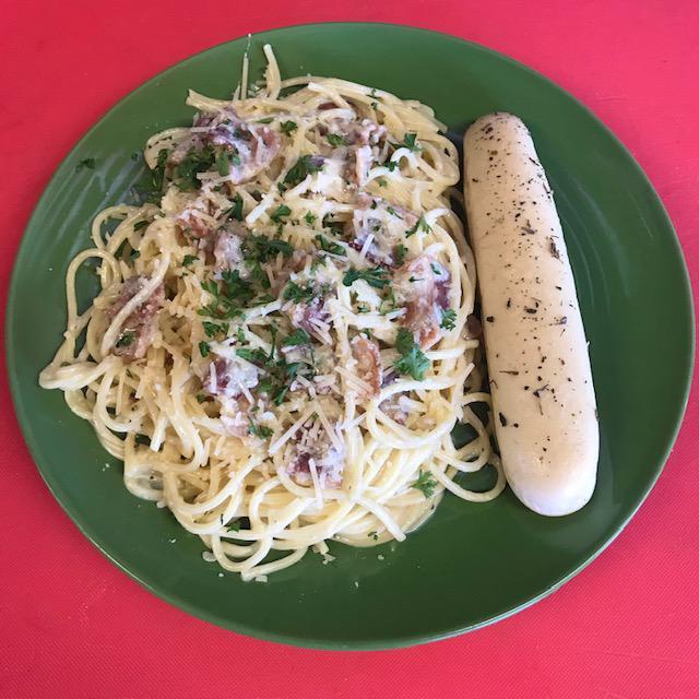 Bacon Carbonara · Fresh cooked to order bacon tossed in a cream sauce. Cream, fresh minced garlic, Parmigiano cheese, fresh diced parsley, fresh crushed pepper corn, whole egg tossed with piping hot spaghetti, topped with Parmigiano and fresh parsley. Served with 1 homemade breadstick.
