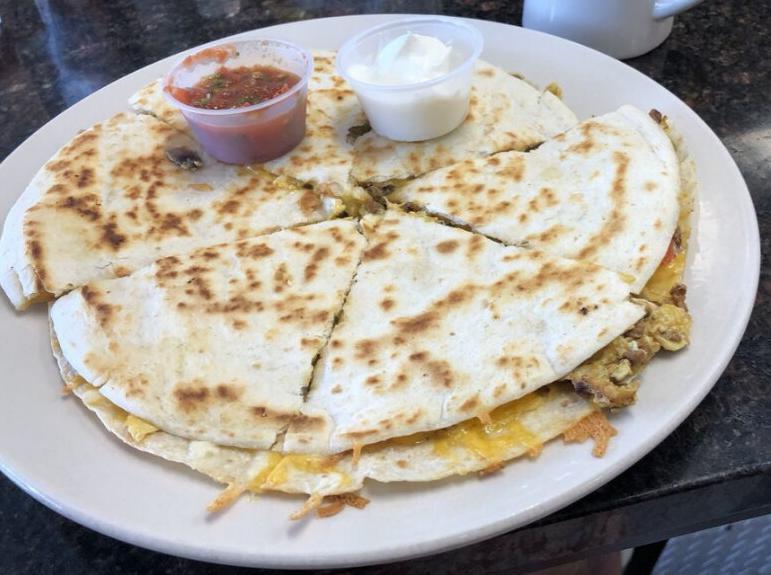 Quesadilla Breakfast · 2 large grilled tortillas with mixed fresh vegetables, eggs, cheddar and Jack cheese and choice of bacon, sausage or ham, garnished with a side of sour cream and salsa. Sub andouille or chorizo for an additional charge.