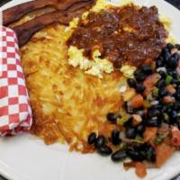 Huevos Rancheros · Choice of meat: bacon, links, chorizo patties. Enjoy 2 eggs topped with ranchero sauce, plus...